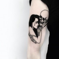 Illustrative style black ink shoulder tattoo of woman with skeleton