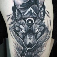 Illustrative style black ink wolf head with crow tattoo on shoulder