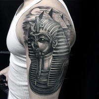 Illustrative style black shoulder tattoo of Egypt pharaoh statue and pyramids