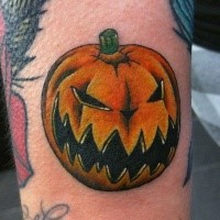 Illustrative style colored arm tattoo of evil pumpkin