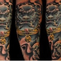 Illustrative style colored arm tattoo of ancient mask and human skull