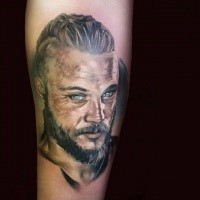Illustrative style colored arm tattoo of viking face