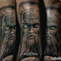 Illustrative style colored arm tattoo of mystical man face