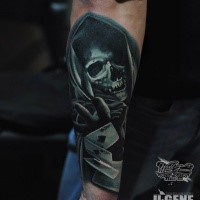 Illustrative style colored arm tattoo of Grimm reaper with cards