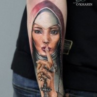 Illustrative style colored arm tattoo of beautiful saint woman with cross