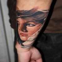 Illustrative style colored arm tattoo of beautiful woman face