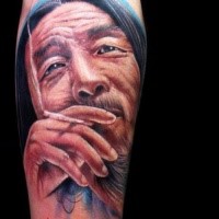 Illustrative style colored arm tattoo of smoking man portrait