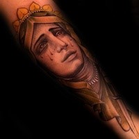 Illustrative style colored crying woman face tattoo on arm