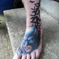 Illustrative style colored foot tattoo of Batman with butterflies