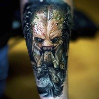 Illustrative style colored forearm tattoo of evil Predator