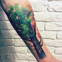 Illustrative style colored forearm tattoo of large tree