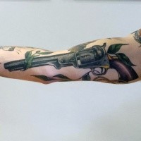 Illustrative style colored forearm tattoo of vintage revolver and flowers