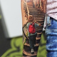 Illustrative style colored forearm tattoo of little boy walking up the stairs