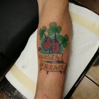 Illustrative style colored forearm tattoo of dice with clover leaf and lettering