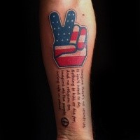 Illustrative style colored forearm tattoo of lettering with American symbol