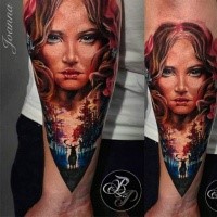Illustrative style colored forearm tattoo of woman face with forest and deer