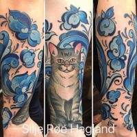 Illustrative style colored forearm tattoo of cat with flowers and plants