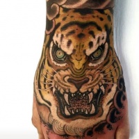 Illustrative style colored hand tattoo of tiger face