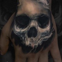 Illustrative style colored hand tattoo of smoking human skull