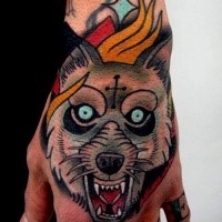 Illustrative style colored hand tattoo of evil wolf with cross and flames