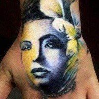 Illustrative style colored hand tattoo of woman with flowers