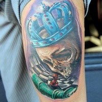 illustrative style colored king skull with crown tattoo on shoulder