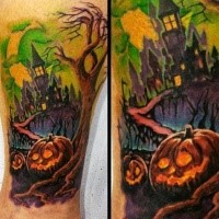 Illustrative style colored leg tattoo of big old creepy house and pumpkins
