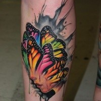 Illustrative style colored leg tattoo of human face stylized with butterfly wings