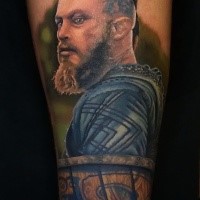Illustrative style colored leg tattoo of Viking hero