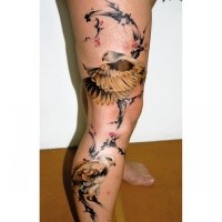 Illustrative style colored leg tattoo of beautiful eagles