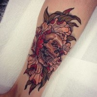 Illustrative style colored leg tattoo of skull with flower