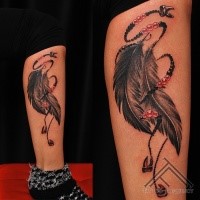 Illustrative style colored leg tattoo of feather totem