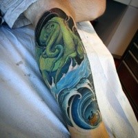 Illustrative style colored leg tattoo of green octopus with waves