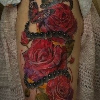 Illustrative style colored shoulder tattoo of roses with jewelry