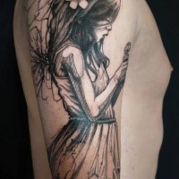 Illustrative style colored shoulder tattoo of sad girl with flowers