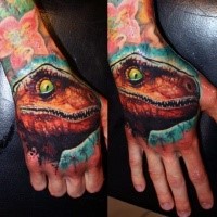 Illustrative style colored small dinosaur head tattoo on hand