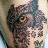 Illustrative style colored thigh tattoo of owl made from puzzle pieces