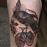 Illustrative style colored thigh tattoo of bird with bicycle
