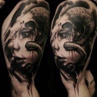 Illustrative style colored thigh tattoo of creepy looking woman with devils horns