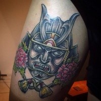 Illustrative style colored thigh tattoo of samurai mask and flowers