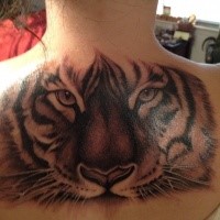 Illustrative style colored upper back tattoo of tiger face