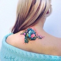 Illustrative style colored upper back tattoo of little flowers