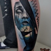 Illustrative style detailed leg tattoo of woman face stylized with ornaments