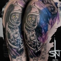 Illustrative style half colored shoulder tattoo of astronaut skeleton with lettering