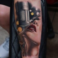 Impossible real life like colored forearm tattoo of woman singer and vintage microphone