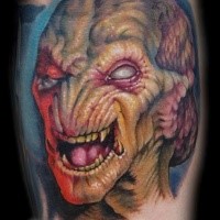 Impressive colored horror style forearm tattoo of alien face
