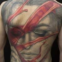Impressive colored whole back tattoo of woman face