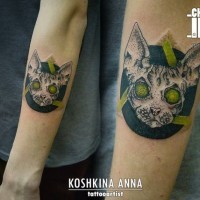 Impressive demonic cat tattoo on forearm with green eyes