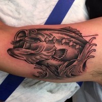 Impressive designed black and white hooked fish tattoo on arm