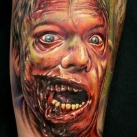Impressive detailed and colored forearm tattoo of zombie face tattoo